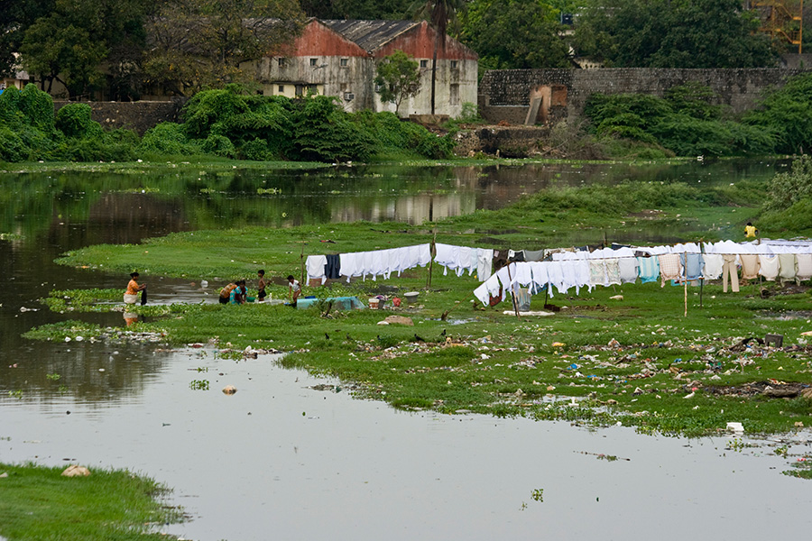 Woman handwashing clothes in the river at Dhobi Ghat, Chennai, 2008 (dbtravel/Alamy)
