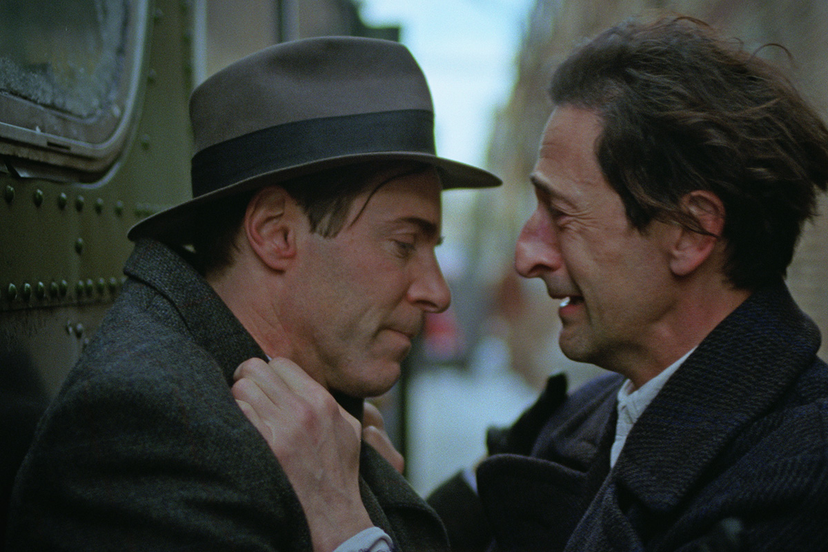 Guy Pearce as Harrison Lee Van Buren and Adrien Brody as László Tóth in The Brutalist